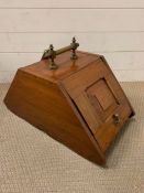 A mahogany coal scuttle with brass handle and shovel