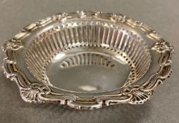 A silver pierced pin dish, hallmarked for Birmingham 1915 by Charles S Green & Co Ltd