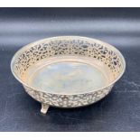 A pierced silver bowl on three feel (Total weight 68g), hallmarked for 1915 by Henry Williamson Ltd
