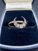 A 9ct gold ring with crescent design.