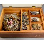 A large jewellery box with a large volume of costume jewellery.