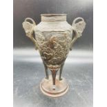 A two handled Oriental bronzed urn with bird design.