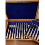 A case set of Mappin and Webb fish knives and forks and a set of dinner knives and forks