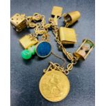 A 9ct gold charm bracelet with a variety of charms and a 1907 sovereign.