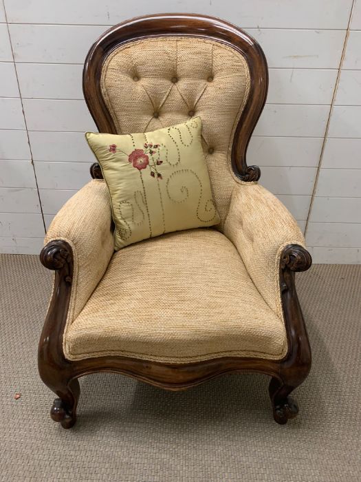 A Rococo style carved open armchair, button back.