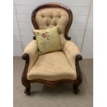 A Rococo style carved open armchair, button back.