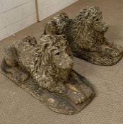 Two stone lion statues with glass eyes