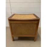 A teak and cane storage stool (H49cm W50cm D38cm)