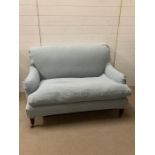 A two seater duck egg blue sofa with loose covers from OKA (H80cm W123cm D70cm)