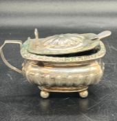 A silver mustard pot with blue glass liner, hallmarked for Birmingham 1886 by Thomas Hayes