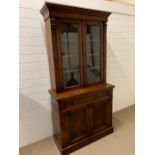 A Mahogany bookcase, upper section with two glazed doors, lower section with carved doors (W 103
