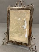 An ornate silver picture frame, hallmarked for Chester by Stokes & Ireland Ltd (William Henry Stokes