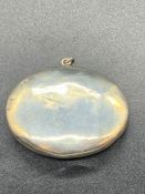 A silver pendant pill box