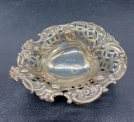 Small silver pierced bowl on three feet, hallmarked for Sheffield by William Hutton & Sons Ltd