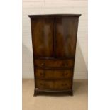 A mahogany bow fronted cupboard with double doors opening to shelves and three drawers below (H153cm