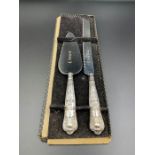 A silver handled bread knife and pie server