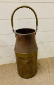 A Copper and brass pail with brass handle and banding.