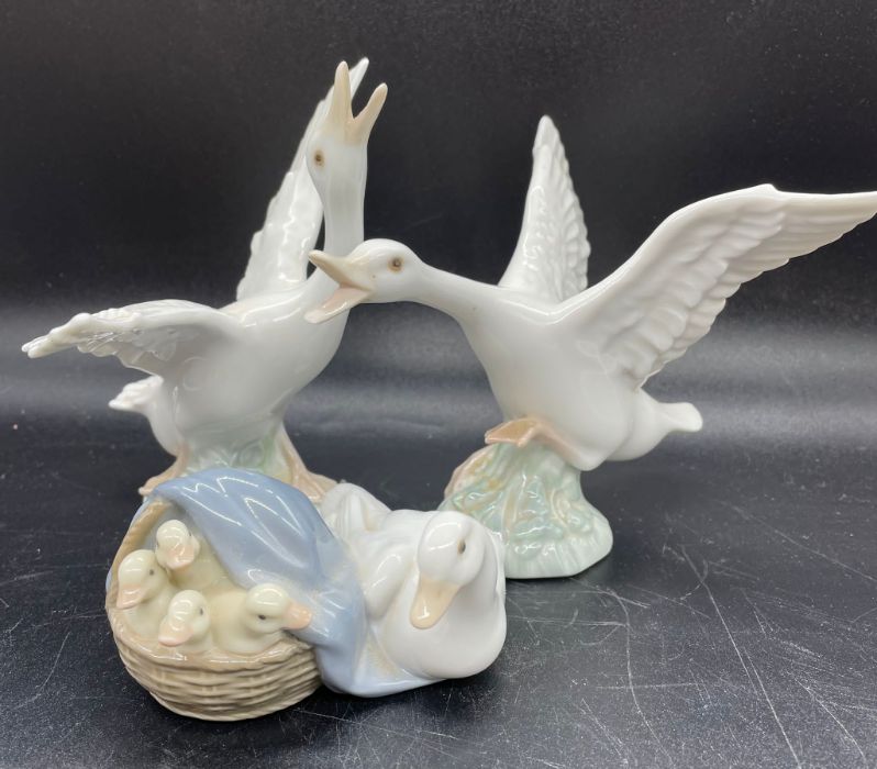 Thee Lladro figures of geese and ducks.