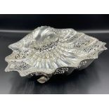A silver bowl with shell design pierced and set on three shell feet by Henry Atkin and hallmarked
