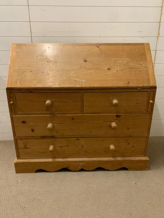 A pine bureau fall opening to an arrangement of drawers, pigeon holes (H107cm W110cm D44cm)