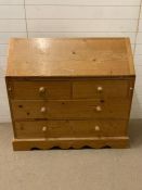 A pine bureau fall opening to an arrangement of drawers, pigeon holes (H107cm W110cm D44cm)