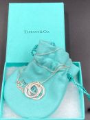 A Tiffany interlocking three ring 1837 pendant on chain with box.