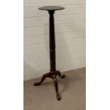 A mahogany plant stand with turned centre pole on tri support legs AF