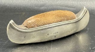 A silver pin cushion in the form of canoe