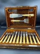 A Walker and Hall silver and bone handled six place setting fish cutlery setting with servers