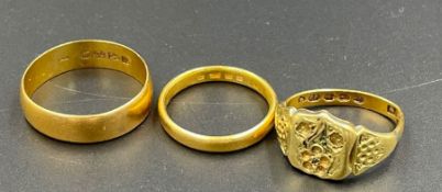 Three 22ct gold rings, two wedding bands and a signet ring (Total Weight 12.2g)