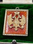 A Faberge pendant by Henrik Wigstrom, silver 88 orange translucent enamel pendant with double headed