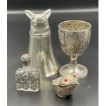 A selection of four white metal curios including a stirup cup