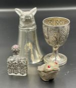 A selection of four white metal curios including a stirup cup
