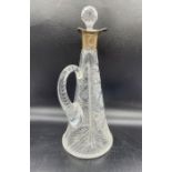 A silver necked cut glass decanter