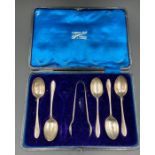 A part set of silver teaspoons and sugar nips (one spoon missing)