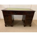 A pedestal desk with green leather top (H77cm W122cm D60cm)