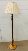 A wooden standard lamp