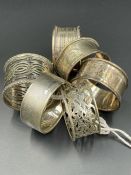 A selection of six silver napkin rings, various designs , makers and hallmarks