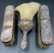 Three hallmarked silver handled and backed brushes