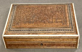 A carved box, decorative with an Indian theme