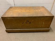 A wooden storage trunk with metal handles to sides and key (H47cm W98cm D56cm)