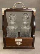 A Tantalus with two cut glass decanters