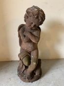 A garden architectural figure of Cupid sitting with his arms crossed (H74cm)