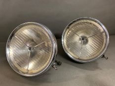 A pair of chrome vintage headlamps/spotlights etched curved glass with logo stamp to top, Lucas,