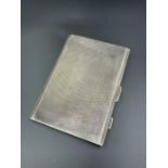 A silver cigarette case, hallmarked Birmingham 1943 by E J Houlston