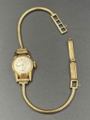 An 18ct gold cocktail watch on a 9ct gold strap (Total weight 11.1g)