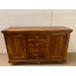 A hardwood sideboard with drawers to centre, flanked by cupboards (H88cm W150cm D45cm)