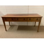 An inlay console table with tapering legs and three drawers (H76cm W165cm D59cm)