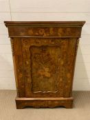 An 19th century walnut pier cabinet of oblong form with floral marquetry and gilt mounts, mould edge
