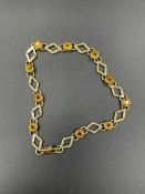 A 9ct gold and citrine style stone bracelet (6.4g)